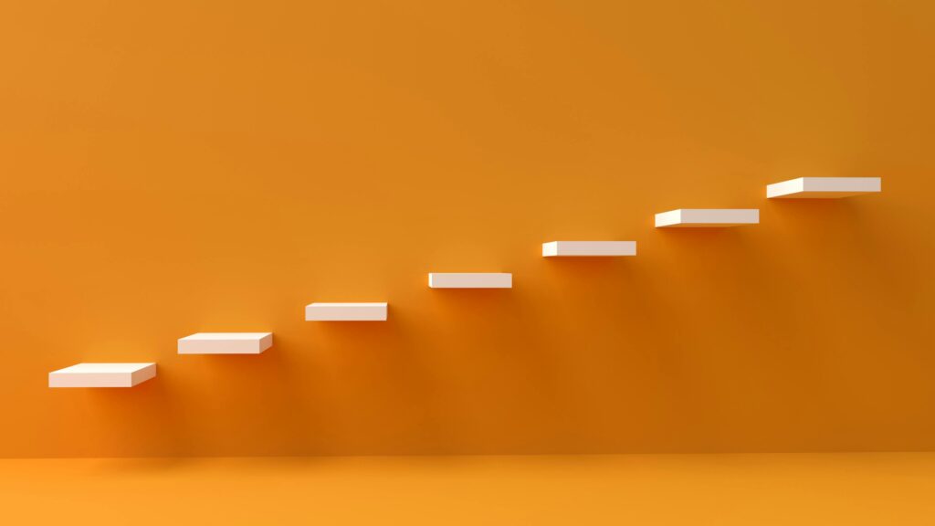 White floating steps on vibrant orange wall create a minimalist and conceptual design.