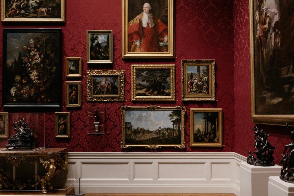 Transform Old Photos with Upcycled Picture Frames Discover classic art in an elegantly designed gallery space with red ornate walls.