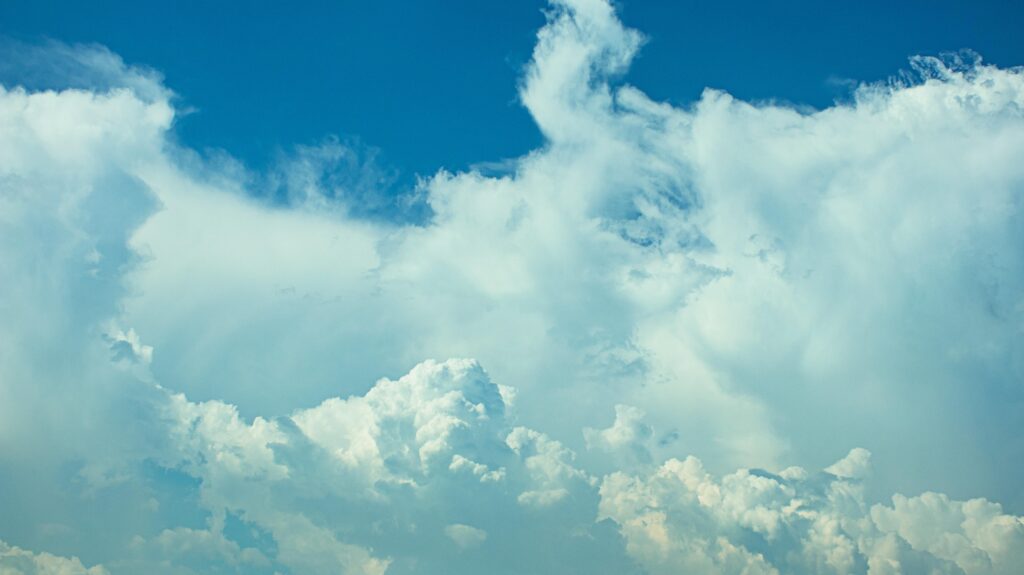 Beautiful skyscape featuring dynamic cloud formations against a vivid blue sky.