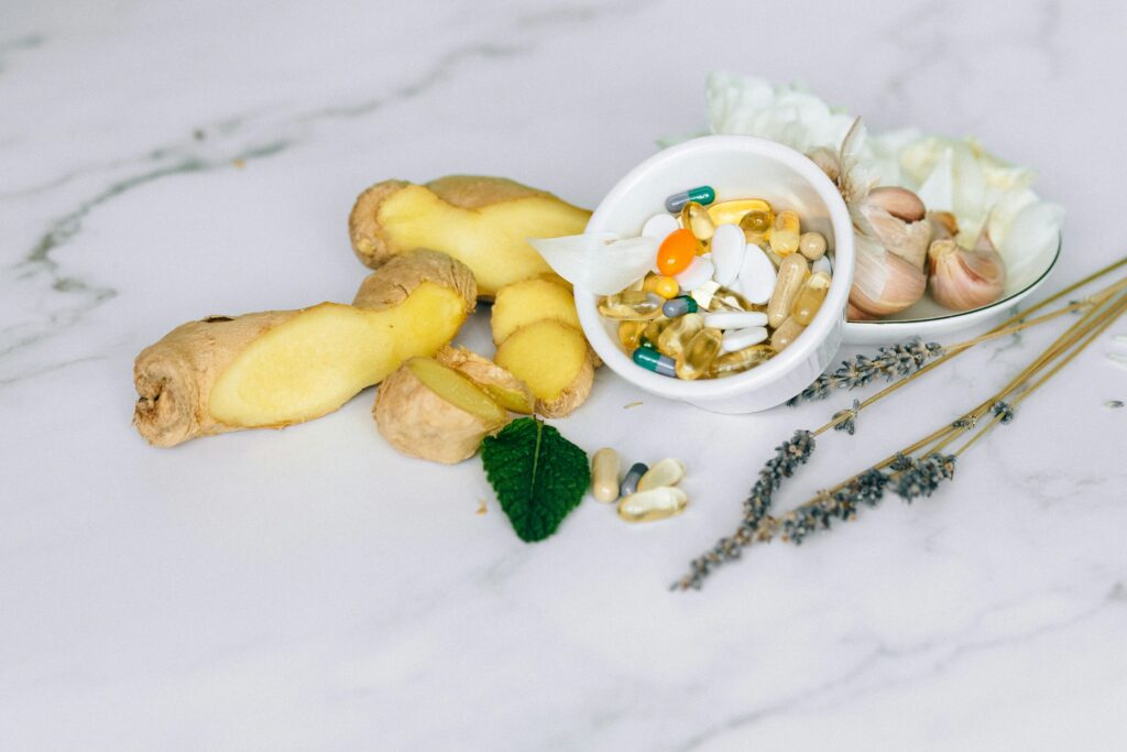 Nutritional Supplements: Benefits & Uses Guide A flat lay featuring ginger, garlic, and various herbal supplements on a marble surface.